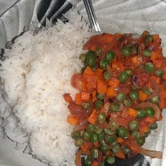 White rice with green peas and carrot gravy A picture of White rice with green peas and carrot gravy.
