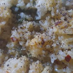 A picture of Spicy rice with spinach and velveeta cheese.