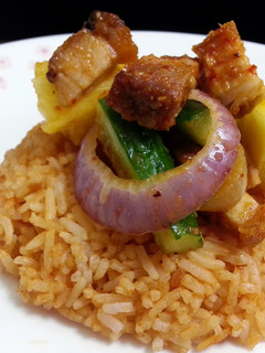 A picture of Korean Sesame Bean Paste Rice Topped with Spicy Roasted Pork Salad.