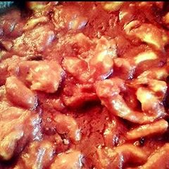 A picture of Chicken with tomato sauce.