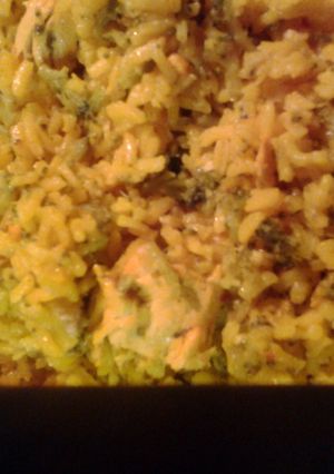 A picture of Italian chicken broccoli and yellow rice.