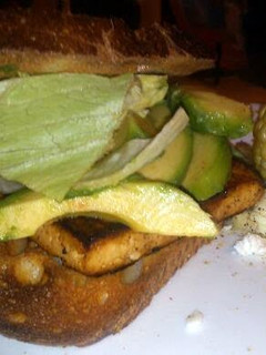 A picture of grilled tofu sandwich with avo & Bacon.