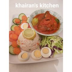 A picture of White basmati rice and fresh tilapia fish stew and salad.