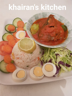 A picture of White basmati rice and fresh tilapia fish stew and salad.