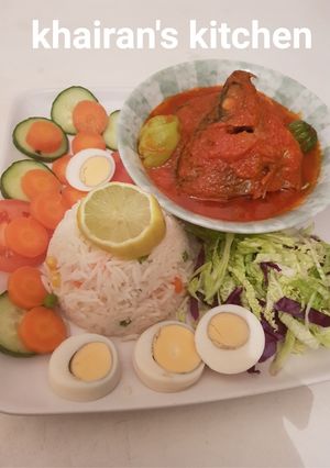 A picture of White basmati rice and fresh tilapia fish stew and salad.