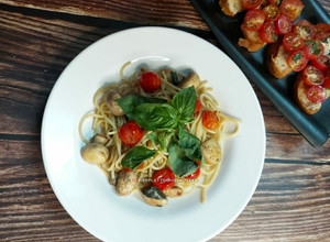 A picture of Spaghetti Aglio e Olio With Mushrooms, Cherry Tomatoes & Basil.