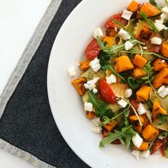 A picture of Sweet Potato Ravioli with Cherry Tomatoes, Goat Cheese and Arugula.