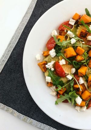 A picture of Sweet Potato Ravioli with Cherry Tomatoes, Goat Cheese and Arugula.