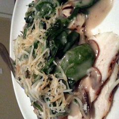 A picture of Creamy mushroom and spinach over grilled chicken breast.