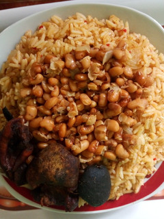 A picture of Jollof rice with honey beans.