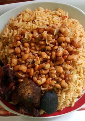 A picture of Jollof rice with honey beans.