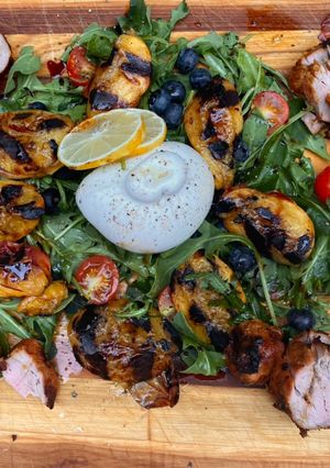 A picture of Grilled peaches, pork and burrata.