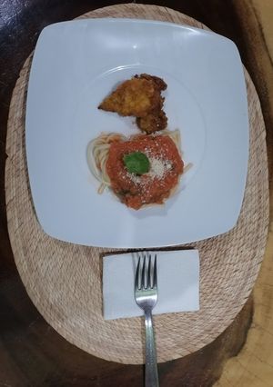 Una foto de Espagueti rojo con milanesa