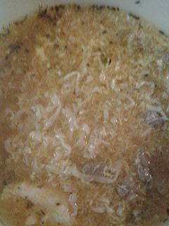 A picture of Liquid chicken soup with noodles.