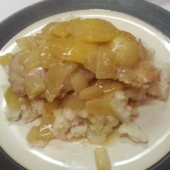 A picture of Pork chops with caramelized apple and onion.