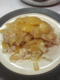 A picture of Pork chops with caramelized apple and onion.