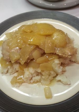 A picture of Pork chops with caramelized apple and onion.