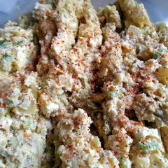 A picture of Potato salad with fresh dill and sour cream.