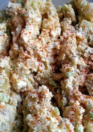 A picture of Potato salad with fresh dill and sour cream.