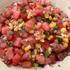 A picture of Tomato Salad with Corn, Feta, and Mint.