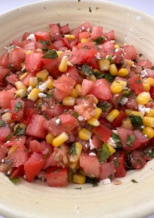 A picture of Tomato Salad with Corn, Feta, and Mint.