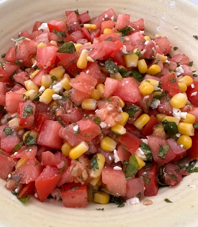 A picture of Tomato Salad with Corn, Feta, and Mint.