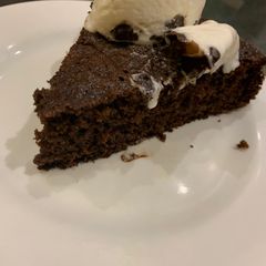 A picture of Chocolate cake with homemade ice cream.