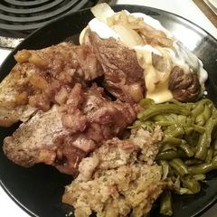 A picture of Pork chops stuffed with homemade stuffing and caramelized apples.