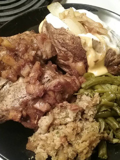 A picture of Pork chops stuffed with homemade stuffing and caramelized apples.