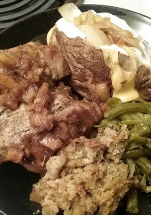 A picture of Pork chops stuffed with homemade stuffing and caramelized apples.