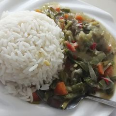A picture of Boiled rice and chicken sauce.