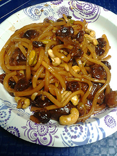 A picture of Fruit nuts and Udon noodle breakfast.