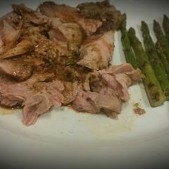 A picture of Slow Roasted Lamb with Charred Asparagus and a White Wine Reduction.