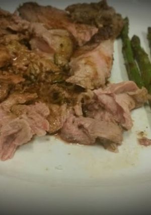 A picture of Slow Roasted Lamb with Charred Asparagus and a White Wine Reduction.