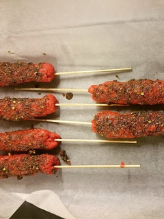 A picture of Minced beef skewer with assorted spices.