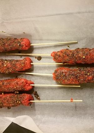 A picture of Minced beef skewer with assorted spices.