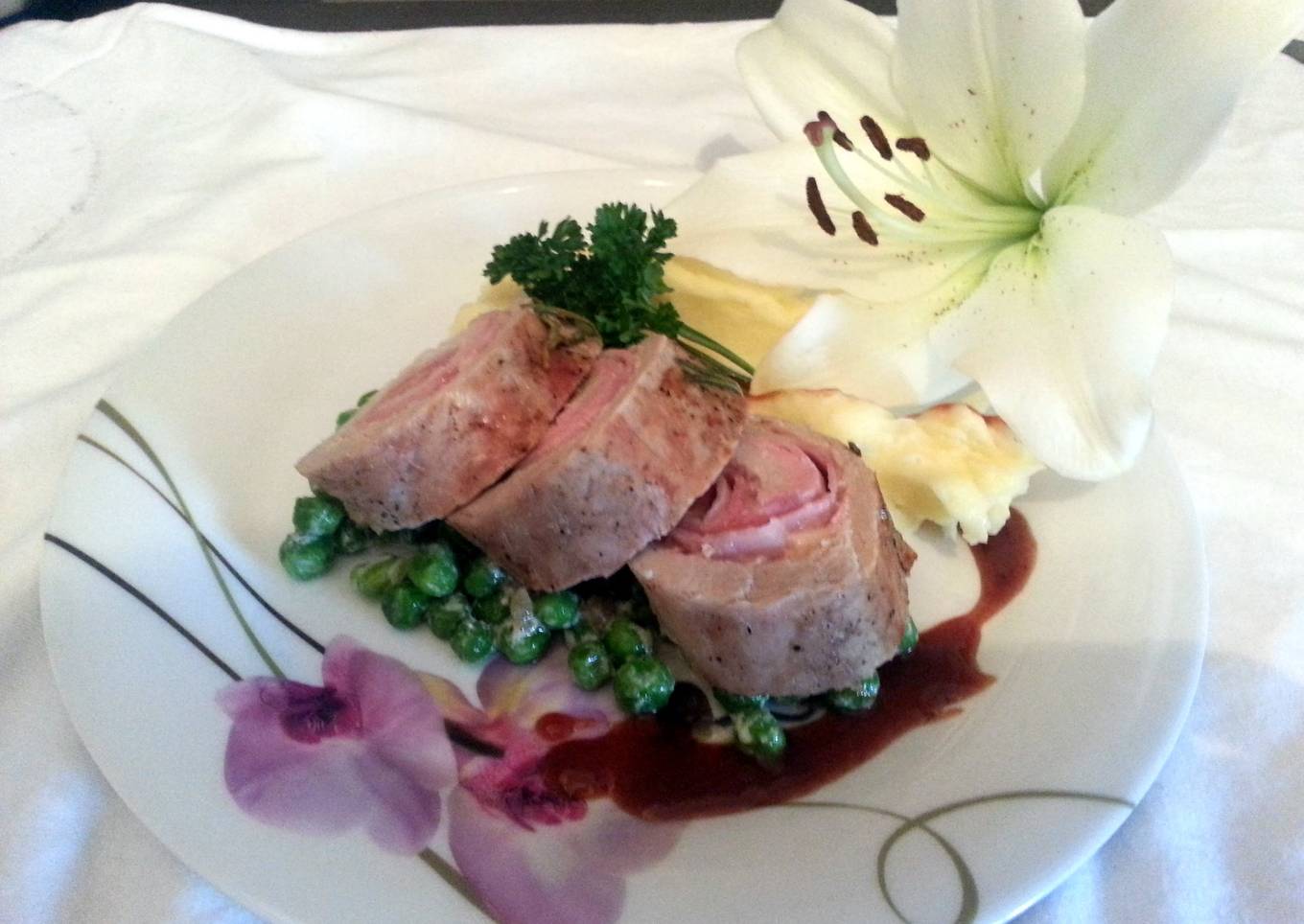 Smoked Cheddar wrapped in pork loin with French peas and plum sauce served with parmesan mashed potatoes