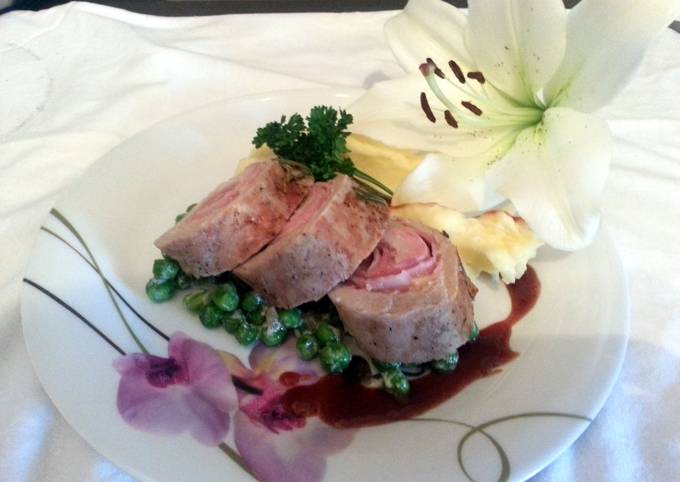Smoked Cheddar wrapped in pork loin with French peas and plum sauce served with parmesan mashed potatoes