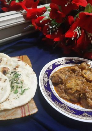 A picture of Chicken masala with tawa garlic naan.