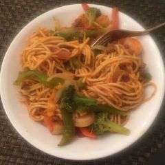 A picture of Spaghetti with green pepper and carrots.