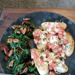 A picture of Spinach and bacon salad with bruschetta.