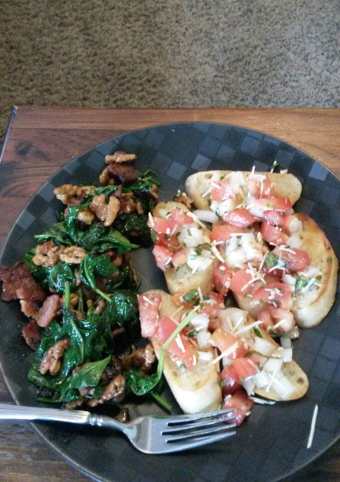 A picture of Spinach and bacon salad with bruschetta.