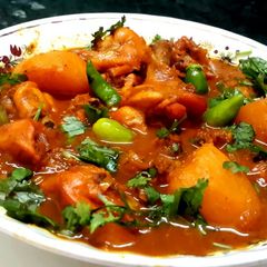 A picture of Chicken in tomato gravy.