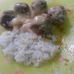 A picture of chicken meatballs in chicken cream soup sauce.