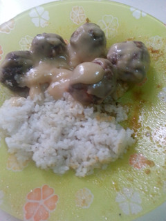 A picture of chicken meatballs in chicken cream soup sauce.