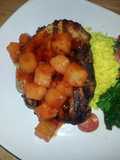 Grilled center cut pork chop with sweet&sour pineapples, saffron rice and garlic spinach tomato saut