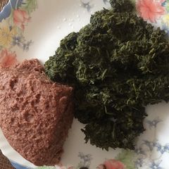 A picture of Kienyeji greens and brown ugali.