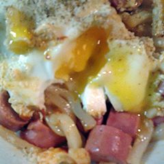 A picture of Udon noodles with egg and Vienna sausages.