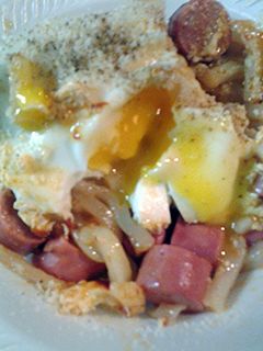 A picture of Udon noodles with egg and Vienna sausages.
