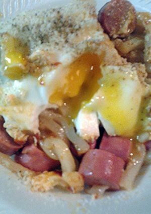 A picture of Udon noodles with egg and Vienna sausages.